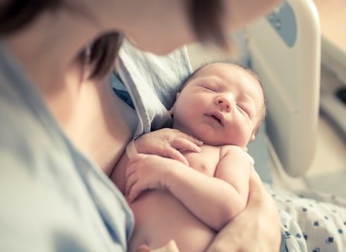 a mother holding her newborn