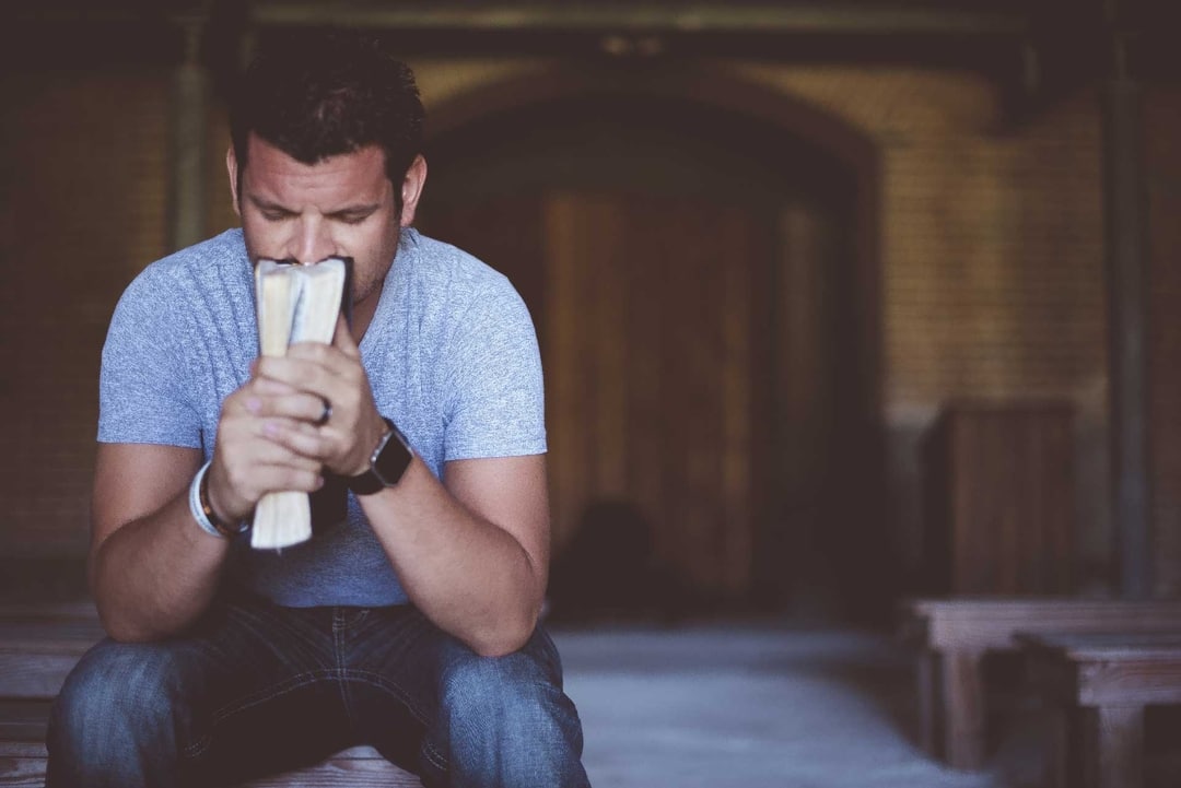 man praying in church